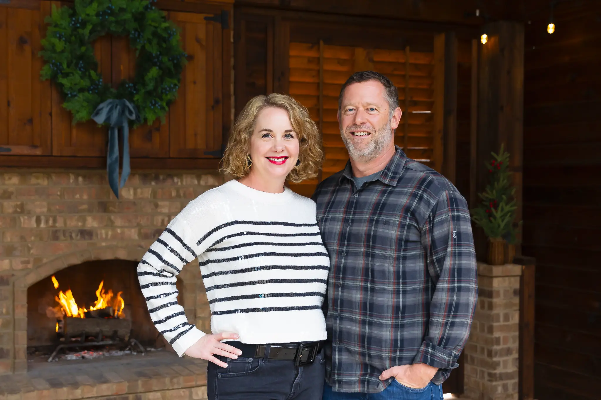 Lauren and Clayton Seargant together by a fireplace